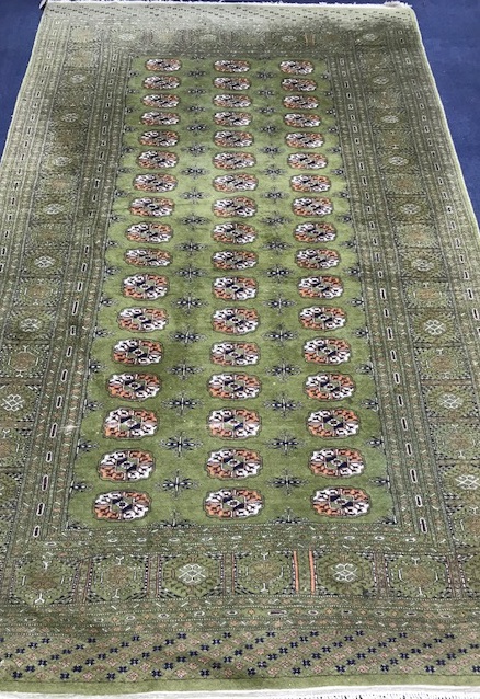 A Bokhara green ground carpet 255cm x 158cm